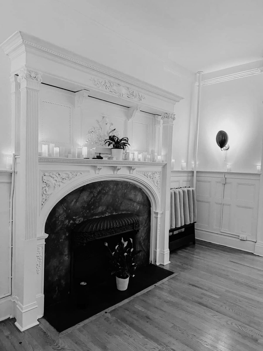 The candlelit marble fireplace in the Altar room at Aura Studio, Upper West Side